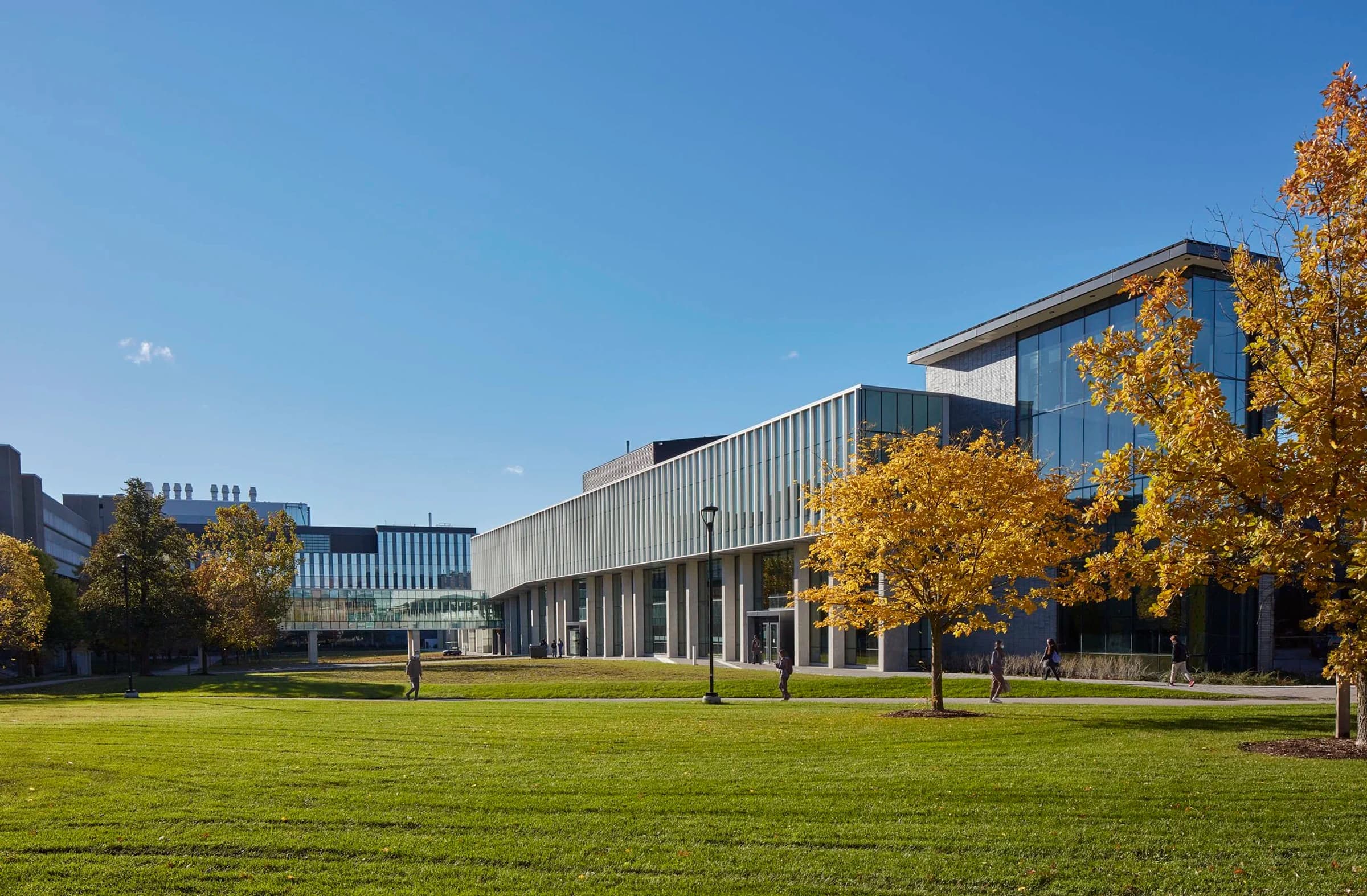 The University of Waterloo Student Life Centre and campus lawn in autumn